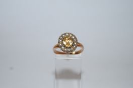 A Victorian gem and pearl set ring, the oval cut stone enclosed by fourteen split pearls,