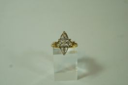 A diamond ring, circa 1920, stamped '18ct', set with eleven stones to the open marquise shaped head,