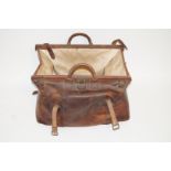 An unusually large leather "Gladstone Bag", with two leather buckled straps,