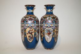 A pair of Japanese cloisonne vases, each with lancet panels depicting dragons and birds,