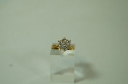 A seven stone diamond cluster 18 carat gold ring, the brilliant cuts totalling approximately 0.