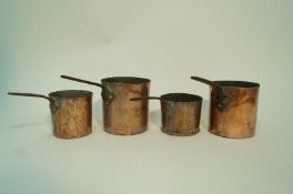 Four 19th century graduated copper cylindrical saucer pans, two stamped T.H.