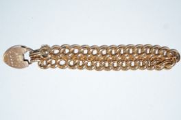 A bracelet' of hollow curb links, stamped '15', to a 15ct gold padlock clasp inscribed,
