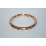 A 9ct gold bangle, of hollow round section, internal diameter 6.3 cm, 11.