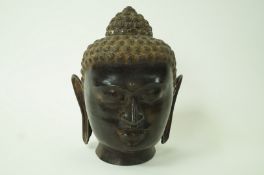 A large South East Asian Bronze model head of a Buddha,