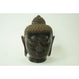 A large South East Asian Bronze model head of a Buddha,