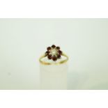 A garnet and diamond 18ct gold cluster ring,