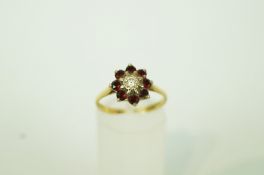 A garnet and diamond 18ct gold cluster ring,