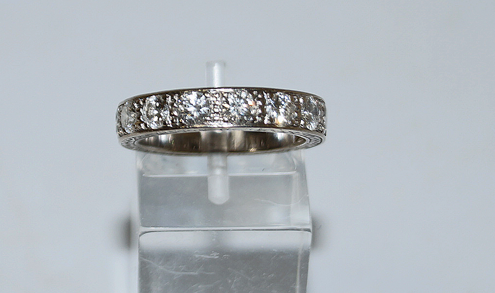 A nine stone diamond half hoop ring, stamped '18ct', the brilliant cuts totalling approximately 1.