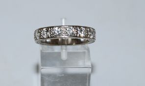 A nine stone diamond half hoop ring, stamped '18ct', the brilliant cuts totalling approximately 1.
