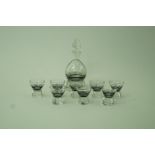 An Art Deco glass decanter along with eight matching glasses,