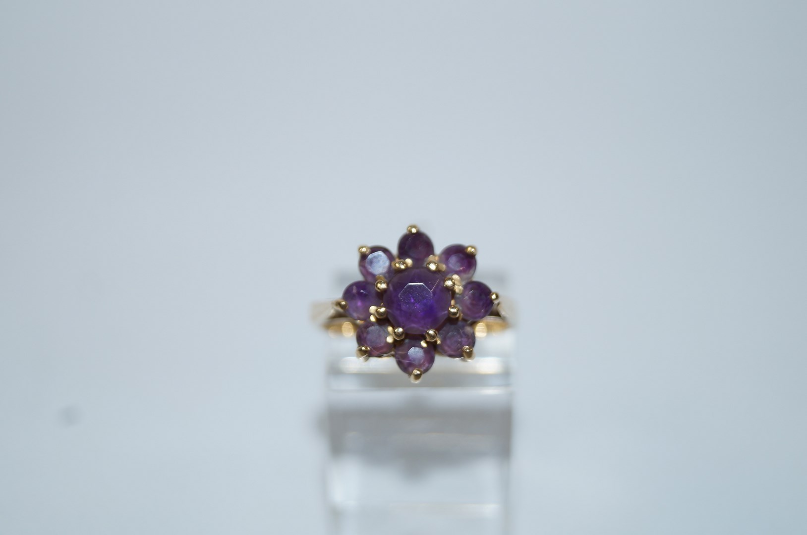 A 9ct gold nine stone amethyst  cluster ring, finger size M1/2, 3.