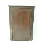 A 19th century mahogany hanging corner cabinet with one panelled door, 108cm high, 77.