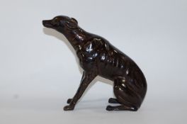 A 20th century bronze model of a seated greyhound,
