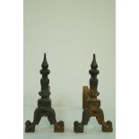 A pair of cast iron fire dogs painted black, 42cm high,