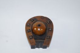 A late Victorian wooden inkwell in the form of a horseshoe, with jockey cap cover, 10.