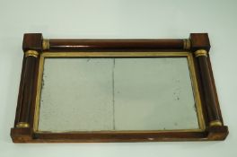 An early 19th century rosewood over mantel mirror with parcel gilt column tops, 46cm x 75.