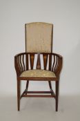 An early 20th mahogany Art Nouveau style armchair with half padded back seat on square tapering