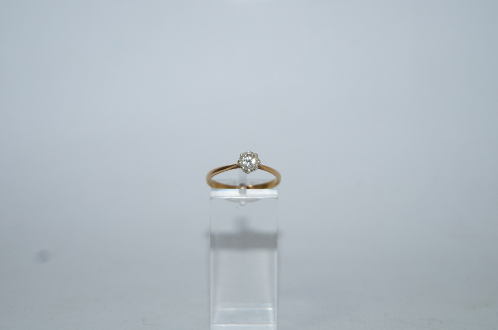 A single stone diamond ring, indistinctly stamped, the brilliant cut of approximately 0.