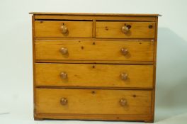 A pine chest of two short and three long drawers, with turned handles, 89cm high, 107cm wide,