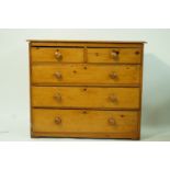 A pine chest of two short and three long drawers, with turned handles, 89cm high, 107cm wide,