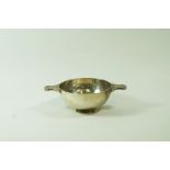 A silver quaich, by Wakely & Wheeler, London 1954, the bowl with Celtic decorated lug handles, 11.