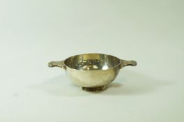 A silver quaich, by Wakely & Wheeler, London 1954, the bowl with Celtic decorated lug handles, 11.