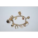 A 9ct gold bracelet, of double curb links, to a padlock clasp, with charms attached, 25.