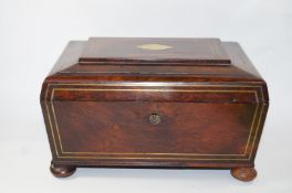 A mid 19th century rosewood needlework box with two handles on bun feet,