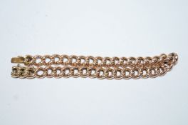 A bracelet, stamped '9ct', of hollow curb links with a hidden box clasp, 20.