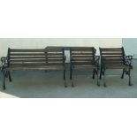 A 20th century cast iron and teak garden set, comprising of a two seater bench (73cm high,