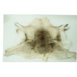 A reindeer fur rug,