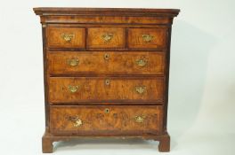 A mainly George II walnut chest of three short and three long drawers with cantered fluted corners