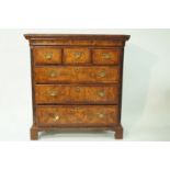 A mainly George II walnut chest of three short and three long drawers with cantered fluted corners