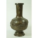 A 20th century Japanese bronze vase, moulded with geese flying over a landscape,