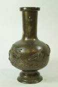 A 20th century Japanese bronze vase, moulded with geese flying over a landscape,