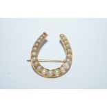 A late Victorian split pearl horse shoe brooch, 2.5 cm wide by 2.7 cm long, 3.