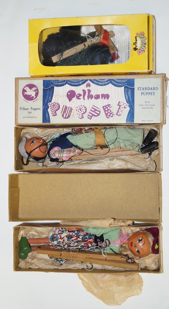 A boxed Pelham puppet of a black poodle with a red ribbon, A4; a Pelham puppet of 'Mitzi',