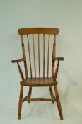 A beech stick back elbow chair with solid seat and turned legs