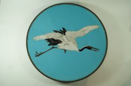 A  Japanese cloissone plate, decorated with crane in flight on a blue ground,