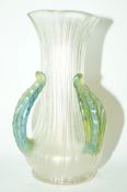 A Loetz style glass vase, of flared form with three green leaf form handles,