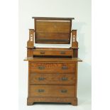 An oak Arts and Crafts style dressing table with swing frame mirror above two small drawers above