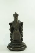 A 20th century Japanese bronze figure, seated on a throne,