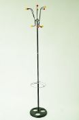 A vintage coat stand, on a black cast iron base with plastic coloured hanging hooks,