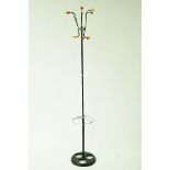 A vintage coat stand, on a black cast iron base with plastic coloured hanging hooks,