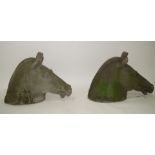 A pair of cast stone horses heads, after the antique,