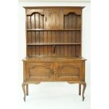 An early 20th century oak Arts and Crafts style dresser,