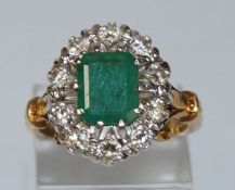 An emerald and diamond 18 carat gold cluster ring,