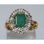 An emerald and diamond 18 carat gold cluster ring,