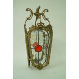 A hanging hall lantern with four stained glass panels,
